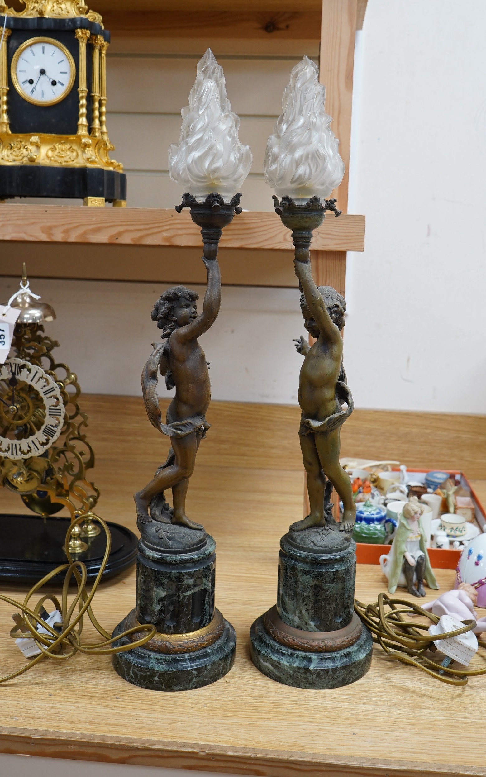 A pair of bronzed spelter ‘putto’ lamps, serpentine marble bases, 60cm. Condition - fair to good, not tested